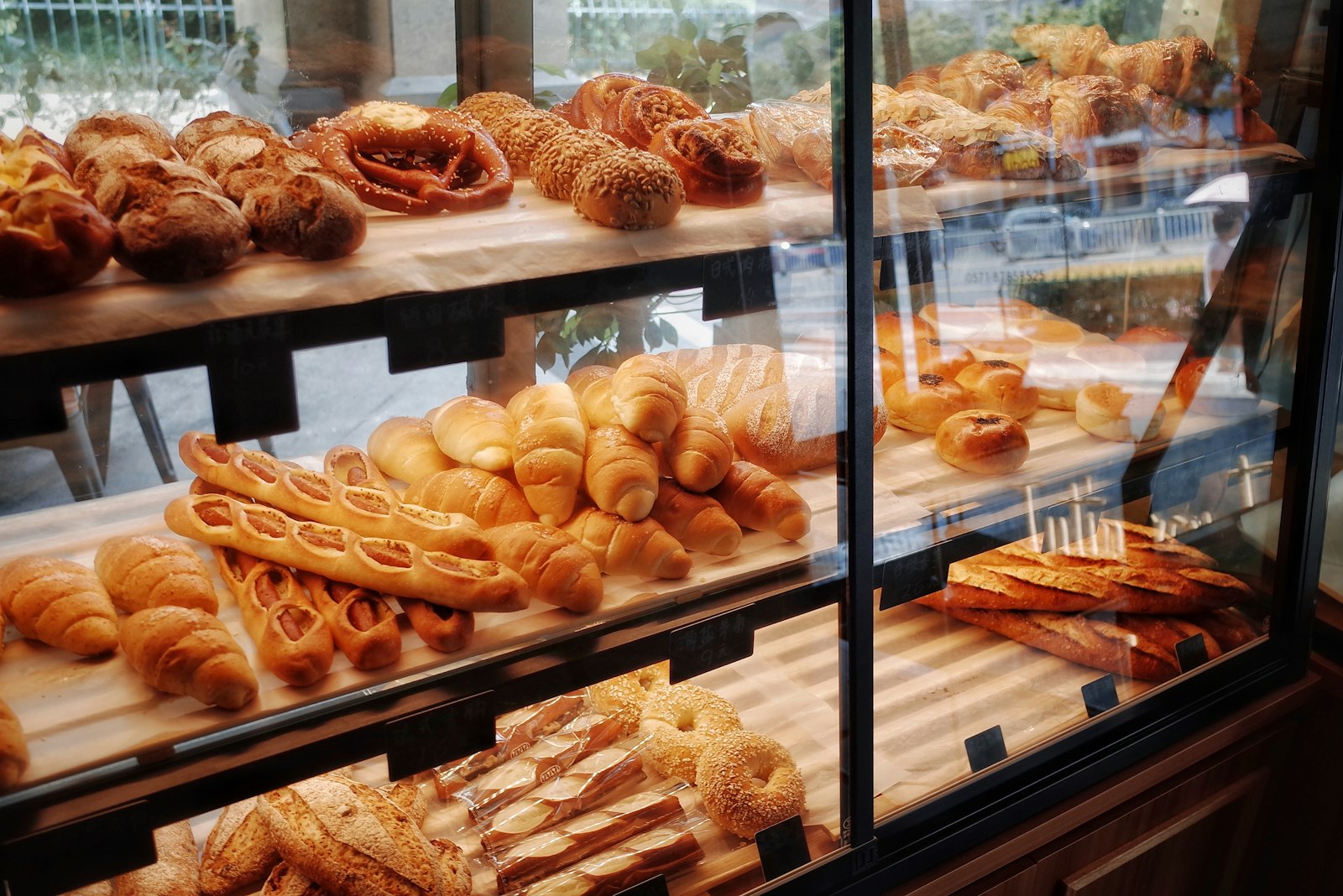 Loaves of bread on a bakery display shelf