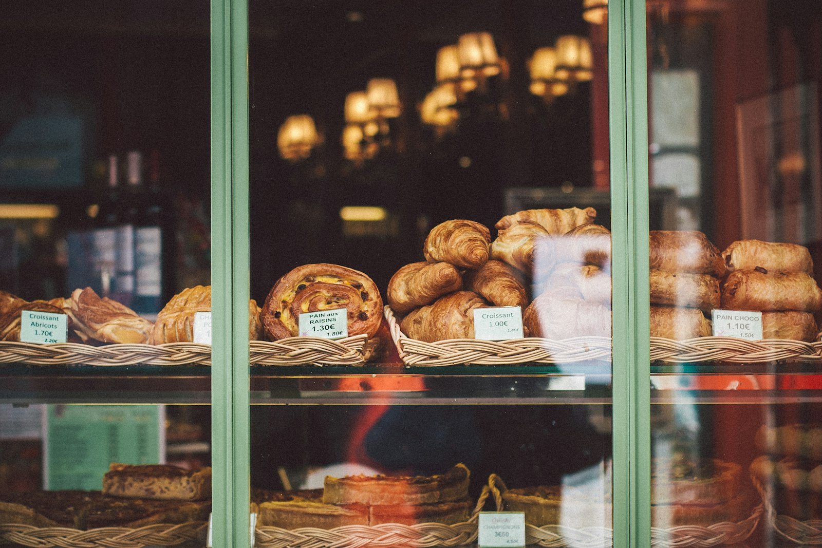 Loaves of bread on a glass bakery display counter